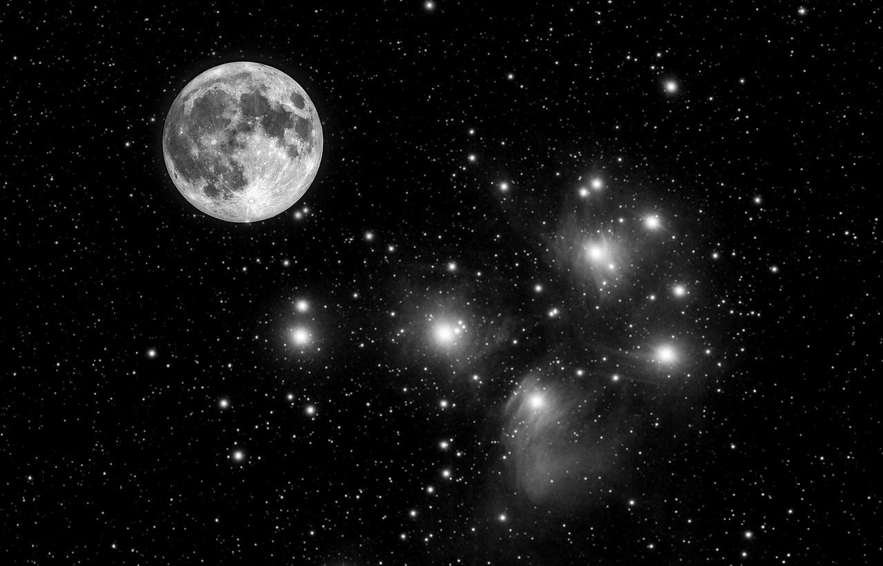 A black and white image of the moon in a starry sky, with numerous bright stars scattered throughout the background.